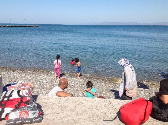 Refugee children eating biscuits and swimming